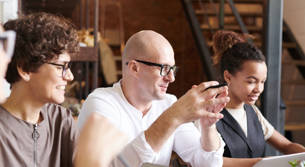 retaining top talent banner image of people round meeting room table